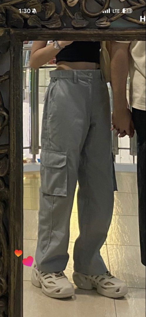 Light Grey Cargo Pants Straight Leg High Waist (Category: Jeans) located in Manila. Submitted by plsbuymyclotheshehe (Listing ID 1469995131, Image 1). Description: - Color: Light grey - Has many pockets - with lock besides - Fit: High-waisted, loose straight leg - Details: Belt loops, button closure, and side utility pockets on both legs - Condition: Worn once for a mirror pic, basically untouched - Material: Sturdy, high-quality fabric - Style: 