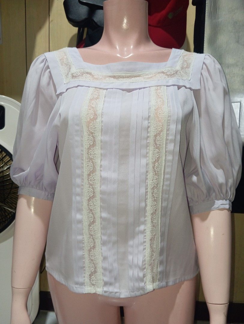Lilac Square Neck Blouse with Lace Trim (Category: Blouses) located in Cebu City. Submitted by smnthdanielle (Listing ID 1470128436, Image 2). Description: - Color: Soft pastel lilac - Design: Square neckline with cream lace trim and pleated front panel - Sleeves: Puff sleeves with comfortable elastic cuffs - Details: Chic vertical lace inserts - Styling: Easy to pair with skirts or high-waisted trousers for casual outings and dates.