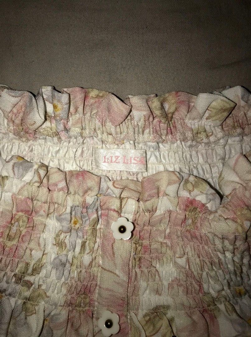 Liz Lisa floral skirt (Category: Skirts) located in Iloilo. Submitted by junpopakoto (Listing ID 1470127076, Image 3). Description: Liz Lisa floral skirt with pink and pastel flowers. High smocked waist, stretchy band at top. Cute flower-shaped buttons down the front. Fully lined underneath so it's not see-through. Super girly and vintage Japanese fashion vibe..
