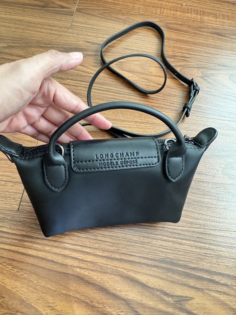 Longchamp Le Pliage Cuir Extra Small Top Handle Bag Black (Category: Cross-body Bags) located in Rizal. Submitted by thrifty.mom (Listing ID 1470074777, Image 2). Description: - Brand: Longchamp - Style: Mini bag / crossbody - Material: Premium smooth leather - Color: Classic black with silver-tone hardware - Closure: Secure zip with flap snap button - Inclusion: Top handle and removable, adjustable shoulder strap - Capacity: Compact size, perfec