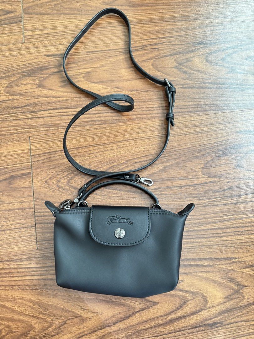 Longchamp Le Pliage Cuir Extra Small Top Handle Bag Black (Category: Cross-body Bags) located in Rizal. Submitted by thrifty.mom (Listing ID 1470074777, Image 1). Description: - Brand: Longchamp - Style: Mini bag / crossbody - Material: Premium smooth leather - Color: Classic black with silver-tone hardware - Closure: Secure zip with flap snap button - Inclusion: Top handle and removable, adjustable shoulder strap - Capacity: Compact size, perfec