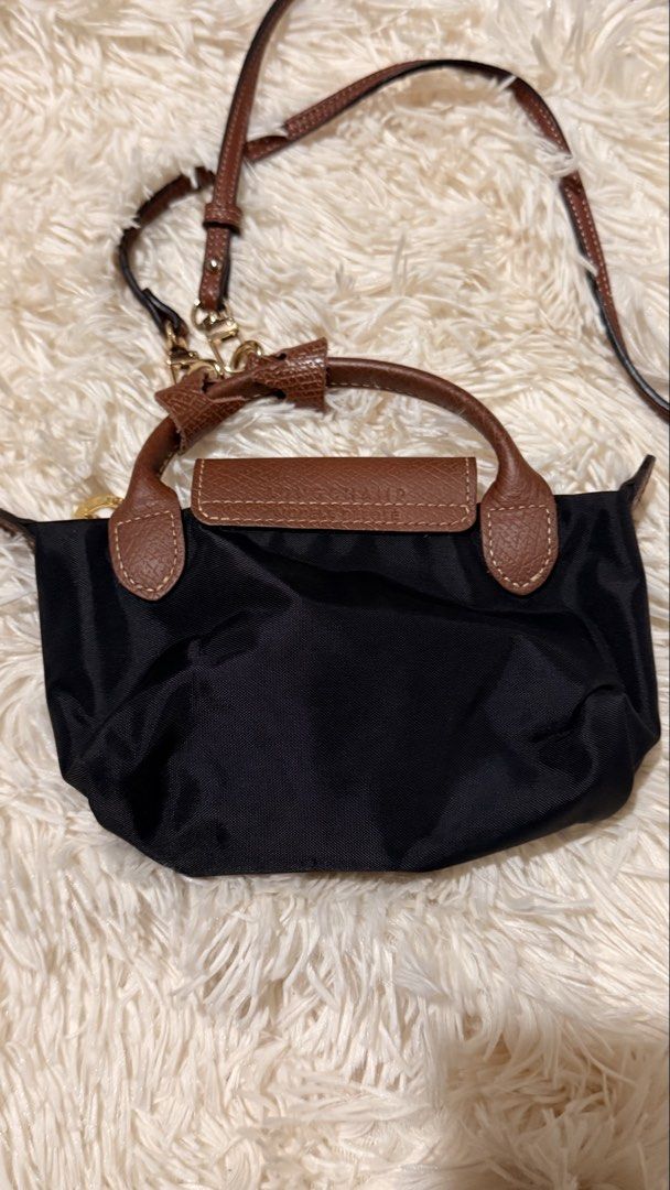 Longchamp Le Pliage Original Pouch (Category: Luxury Bags & Wallets) located in Pasay City. Submitted by erinsclosetph (Listing ID 1470022929, Image 2). Description: Preloved and in excellent overall condition. Features the iconic lightweight nylon body with leather flap and comes with shoulder straps for versatile styling. Condition: Rank A–AB Flaws: Minor scratch on the leather flap and signs of wear underneath. Nylon is in excellent condition,