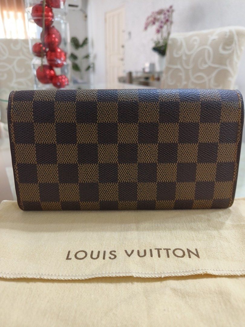Louis Vuitton Damier Ebene Long Wallet (Category: Luxury Bags & Wallets) located in Las Pinas. Submitted by apple.mendoza.chan (Listing ID 1470014084, Image 2). Description: - Authentic Louis Vuitton long wallet in timeless Damier Ebene canvas - Brown leather interior featuring multiple card slots, bill compartments, and a zippered coin pocket - Secure gold-tone snap button closure and matching hardware - Condition: Excellent, well-cared-for pre-