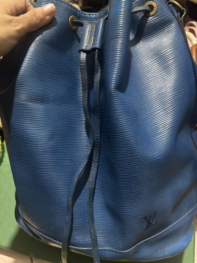 LV epi bucket noe orig (Category: Luxury Bags & Wallets) located in Rizal. Submitted by riri.rarapreloved (Listing ID 1470001115, Image 1). Description: - Brand: Louis Vuitton - Style: Epi Leather Bucket Bag - Origin: Made in France - Color: Blue - Material: Iconic textured Epi leather with debossed LV logo - Hardware: Branded brass eyelets and D-rings - Closure: Drawstring - Strap: Adjustable - Condition: Visible wear on drawstring edges, strap 