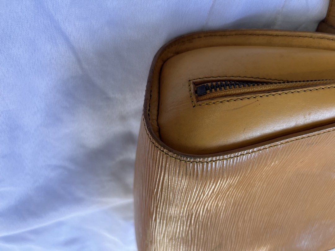 Louis Vuitton Epi Leather Yellow Mantes Backpack (Category: Luxury Bags & Wallets) located in Manila. Submitted by mightylion-ce6ea7 (Listing ID 1469954024, Image 3). Description: - vintage Louis Vuitton backpack - Crafted from durable yellow Epi leather with gold-toned hardware - Features adjustable shoulder straps, secure top zip closure, and an external vertical zip pocket - Classic textured finish with subtle embossed LV logo on the bottom co