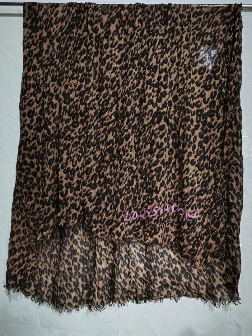 Louis Vuitton Leopard Print Scarf (Category: Scarves) located in General Tinio. Submitted by mariyaspreloved (Listing ID 1469953168, Image 1). Description: - Design: Brown and black leopard print with pink Louis Vuitton signature lettering near the hem - Material: Soft, lightweight fabric, Made in Italy - Details: Trendy raw frayed edges all around - Season: Great layering piece for cooler weather - Condition: Excellent, beautifully maintained.
