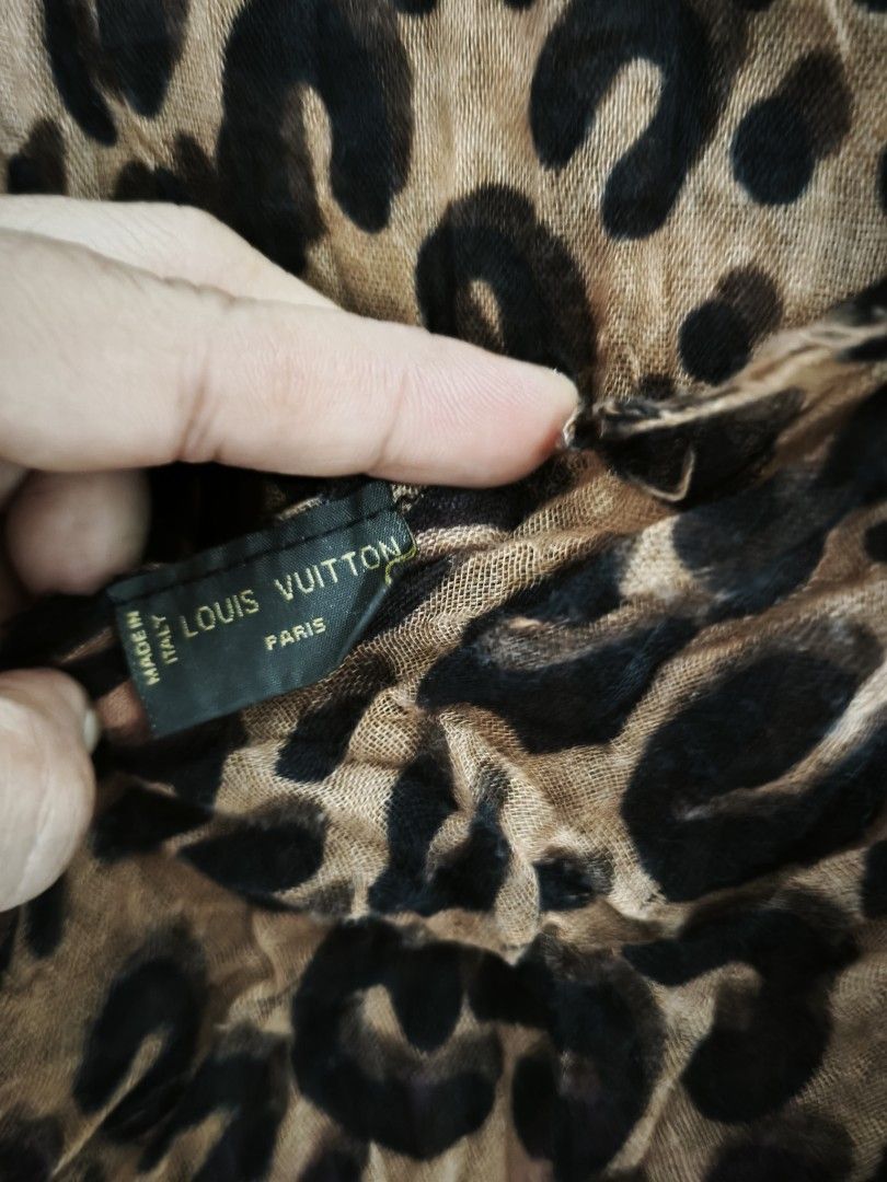 Louis Vuitton Leopard Print Scarf (Category: Scarves) located in General Tinio. Submitted by mariyaspreloved (Listing ID 1469953168, Image 2). Description: - Design: Brown and black leopard print with pink Louis Vuitton signature lettering near the hem - Material: Soft, lightweight fabric, Made in Italy - Details: Trendy raw frayed edges all around - Season: Great layering piece for cooler weather - Condition: Excellent, beautifully maintained.