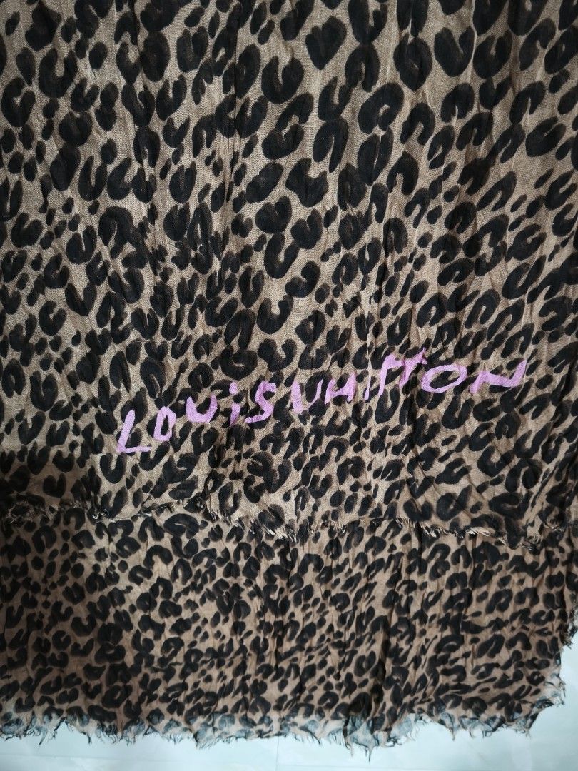 Louis Vuitton Leopard Print Scarf (Category: Scarves) located in General Tinio. Submitted by mariyaspreloved (Listing ID 1469953168, Image 3). Description: - Design: Brown and black leopard print with pink Louis Vuitton signature lettering near the hem - Material: Soft, lightweight fabric, Made in Italy - Details: Trendy raw frayed edges all around - Season: Great layering piece for cooler weather - Condition: Excellent, beautifully maintained.
