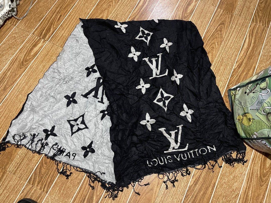 Louis Vuitton Monogram Scarf Black and Grey (Category: Luxury Accessories) located in Mandaluyong City. Submitted by mark2pac (Listing ID 1470054211, Image 1). Description: - Authentic Louis Vuitton scarf in a stylish black and grey colorway - Features iconic monogram pattern with LV initials and floral motifs - Distinct Louis Vuitton lettering near the bottom edge - Trendy fringe detailing on both ends - Lightweight fabric with a modern crinkled