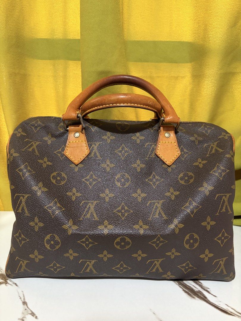 Louis Vuitton Monogram Speedy Handbag (Category: Purses & Pouches) located in Borongan. Submitted by charmspreloveddd (Listing ID 1469980928, Image 1). Description: - Authentic and coded Vintage Monogram coated canvas with vachetta leather handles and trim - Classic gold-tone hardware and secure zip closure - Brown fabric interior lining featuring a convenient small side pocket - Made in France - Date code: SP0068 - Timeless and versatile everyda