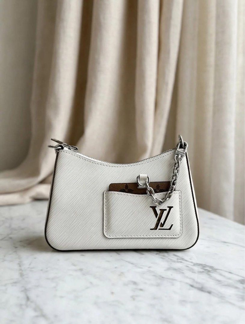 Louis Vuitton White Epi Leather Mini Pochette Bag (Category: Luxury Bags & Wallets) located in Mandaluyong City. Submitted by kaikhaleb (Listing ID 1469953817, Image 1). Description: Louis Vuitton White Epi Leather excellent condition. Series/Year: Microchipped Inclusion: Entrupy, Dustbag, 2 Strap & Coin Purse- 95,000.