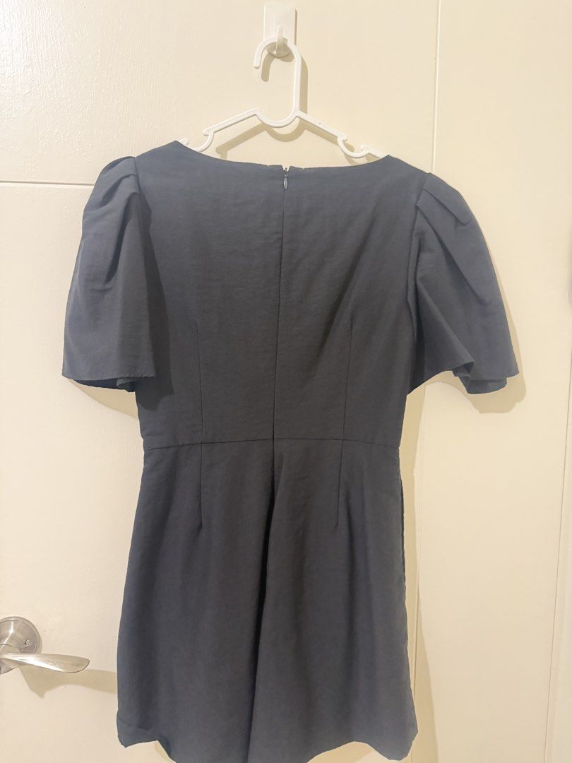 Love Bonito Black Ruched Romper (Category: Rompers) located in Pasay City. Submitted by triciasclosetph (Listing ID 1470065787, Image 3). Description: - Brand: Love Bonito - Item: Black Romper - Size: S (Fits UK 8 / US 4) - Design: Square neckline, pleated chest overlay, puffy short sleeves, and back zip closure - Occasion: Versatile for dinner dates or weekend outings - Condition: Excellent / Like new - DM to chat or meetup!.