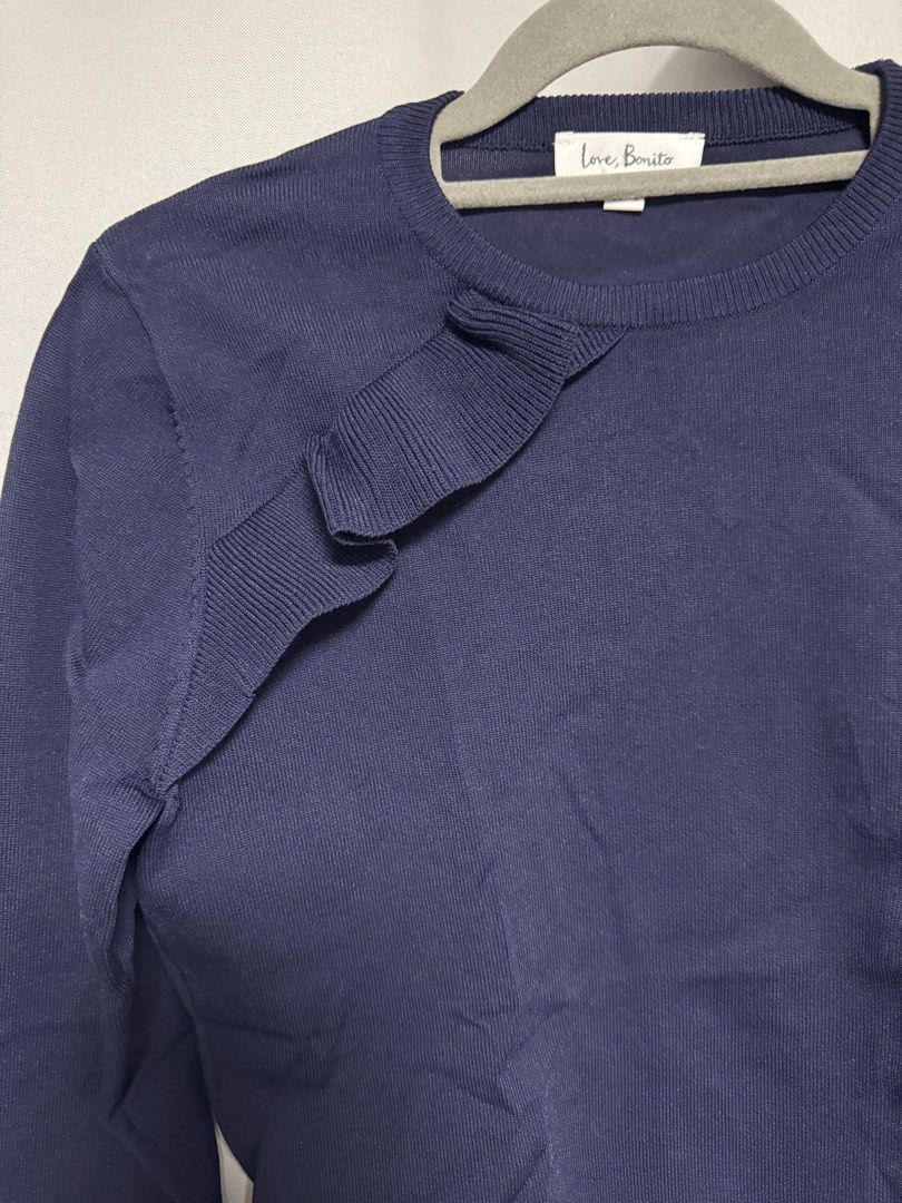 Love Bonito Navy Blue Ruffle Knit Top (Category: Sleeveless) located in Calamba. Submitted by cheriiv (Listing ID 1469953097, Image 3). Description: Washed, never worn - Brand: Love Bonito - Color: Classic navy blue - Size: M (UK 10, US 6) - Design: Round neckline with a chic ribbed ruffle detail on the right shoulder and chest - Fit: Fitted silhouette with ribbed cuffs and hem - Material: Clean, soft fabric with great stretch - Styling: Versatil