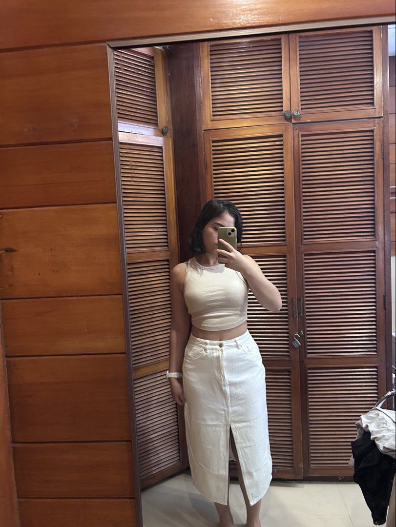 Love Bonito White Denim Midi Skirt (Category: Skirts) located in Cebu City. Submitted by shopmikascloset (Listing ID 1469955621, Image 1). Description: Needs minor restitching in the slit area in photo. Brand: Love Bonito - Style: White denim midi skirt with front slit and classic five-pocket design - Size: UK 10 / US 6 - Material: Sturdy, durable cotton - Condition: Worn a few times, minor fraying near the slit seam (check photos) - Versatile pi