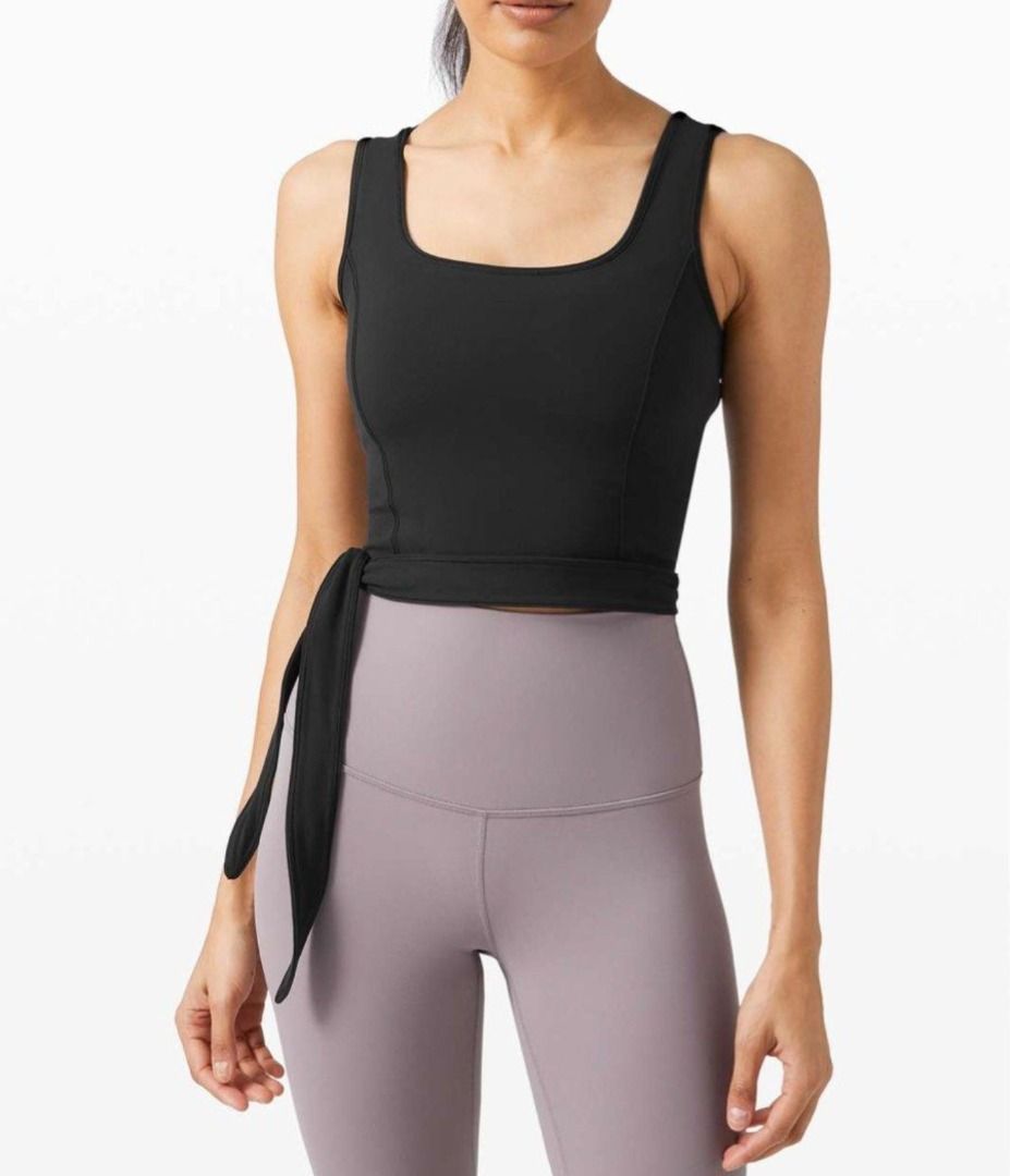 Lululemon Black Tie-Side Tank Top Crop Top (Category: Sleeveless) located in Pasig City. Submitted by peachesncreams (Listing ID 1470102600, Image 1). Description: - Brand: Lululemon - Style: Black cropped tank top with square neckline and wide straps - Features: Adjustable side tie wrap fit, racerback, and reflective logo near the hem - Material: Soft, stretchy athletic fabric - Condition: Excellent/Good as new - Best for: Workouts, running erra
