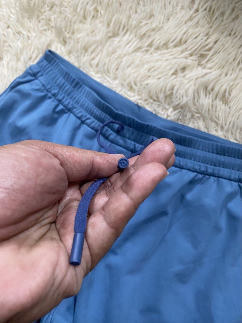 Lululemon Blue Pants Size M (Category: Activewear) located in Manila. Submitted by switchcity (Listing ID 1470075618, Image 2). Description: - Brand: Lululemon - Color: Blue - Size: Medium fits 30-34 - Fit: Relaxed straight leg - Waistband: Elastic with matching drawstring and logo-detail ends - Pockets: Two back welt pockets with signature embroidered logo - Material: Comfortable synthetic blend - Condition: Great, clean, and well-kept.