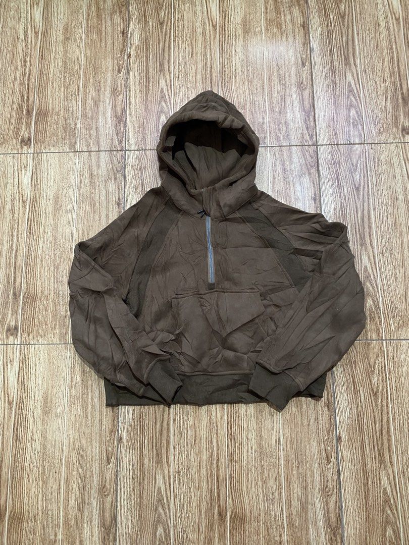 Lululemon Brown Half-Zip Hoodie Size 6 (Category: Coats, Jackets and Outerwear) located in Manila. Submitted by christian.thrift_4 (Listing ID 1469953603, Image 1). Description: Lululemon brown half-zip hoodie in size 6. Ribbed panels under the arms and side body. Front kangaroo pocket with hood and drawstring. Soft fleece interior lining. Made with cotton, polyester, nylon, and elastane blend. Tag inside the collar. Great dark brown neutral shad