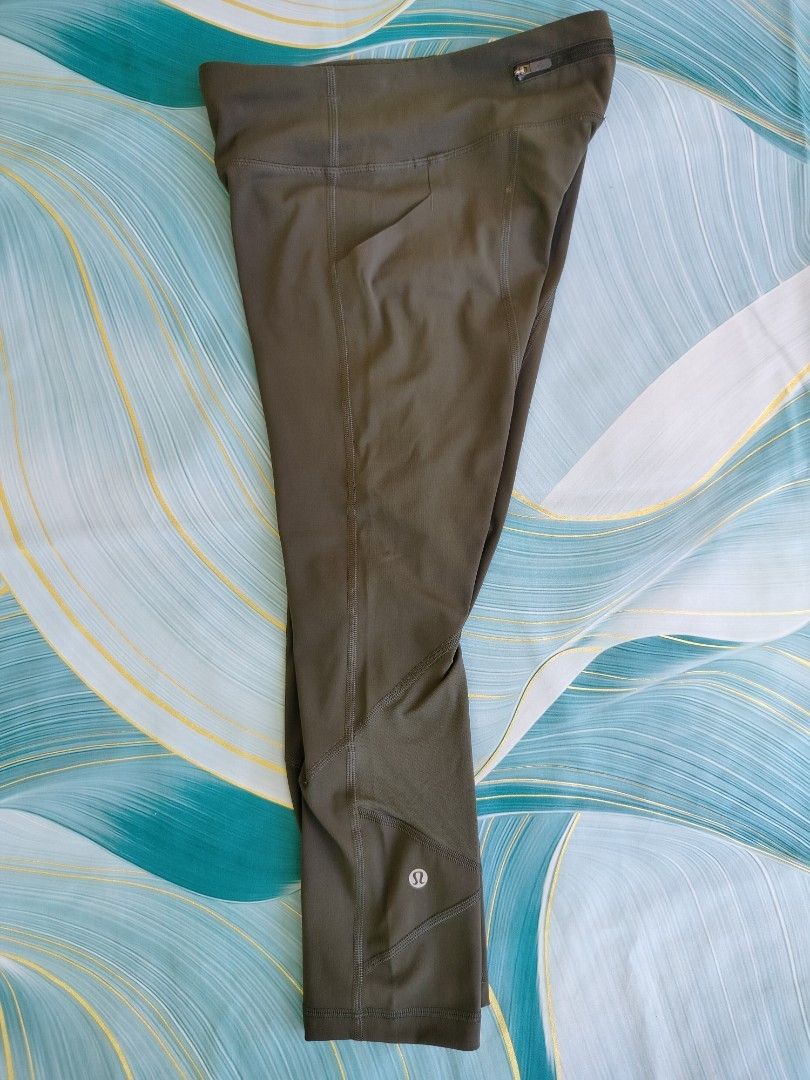 Lululemon Olive Green Crop Leggings Size 4 (Category: Activewear) located in Manila. Submitted by geraldquinto_917 (Listing ID 1470080067, Image 3). Description: - Brand: Lululemon - Size: 4 -Length 30 - Color: Olive Green - Length: Mid-calf / Crop - Features: Geometric leg panels, secure back zippered pocket, side drop-in pockets - Details: Iconic omega logo near hem and inside waistband size dot - Condition: Clean, stretchy fabric, great for ru