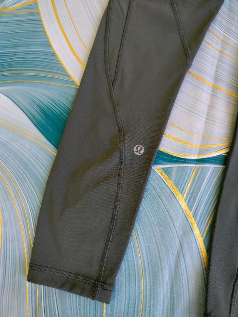 Lululemon Olive Green Leggings Size 2 (Category: Activewear) located in Manila. Submitted by geraldquinto_917 (Listing ID 1470079729, Image 3). Description: - Brand: Lululemon - Color: Olive Green - Size: 2 (tag inside waistband) -Length 33 - Features: Side pockets, reflective logo near lower leg hem - Design: Supportive curved seam lines on front and back - Fabric: Breathable, minimalist athletic wear.