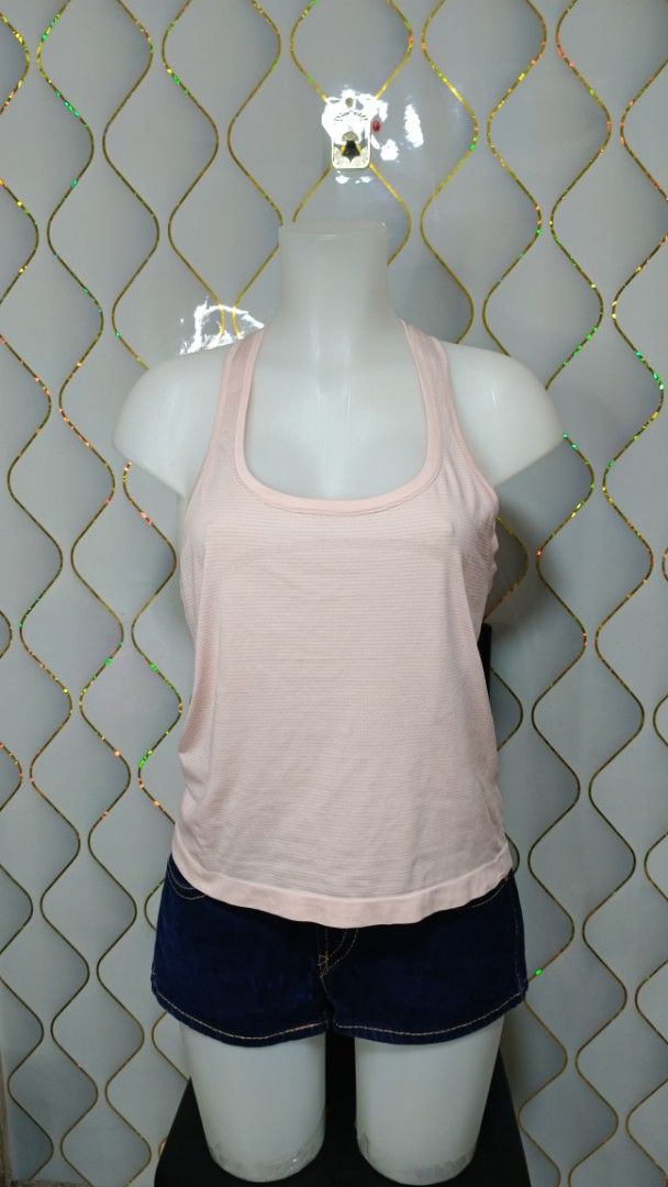 Lululemon Racerback Tank Top Still Your Mind (Category: Sleeveless) located in Manila. Submitted by zariyah.1986 (Listing ID 1469955044, Image 1). Description: - Brand: Lululemon - Style: Seamless racerback tank top with subtle stripes - Features: Breathable fabric, iconic silver reflective logo on back collar - Special Detail: Motivational text prints inside the hem ('STILL YOUR MIND' & 'MOVE YOUR BODY') - Condition: Great for workouts, yoga, an