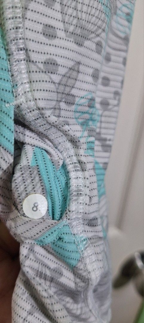 Lululemon tech run cap sleeve with mesh panel dot size 8 (Category: Activewear) located in San Pablo. Submitted by allyourbrandedneeds (Listing ID 1470139368, Image 3). Description: - Brand: Lululemon - Size: 8 - Color/Print: Grey, white, and teal with mixed floral and polka dot pattern - Design: Scoop neckline with a breathable mesh panel across the midsection - Fabric: Lightweight, airy, and sweat-friendly - Condition: Excellent.