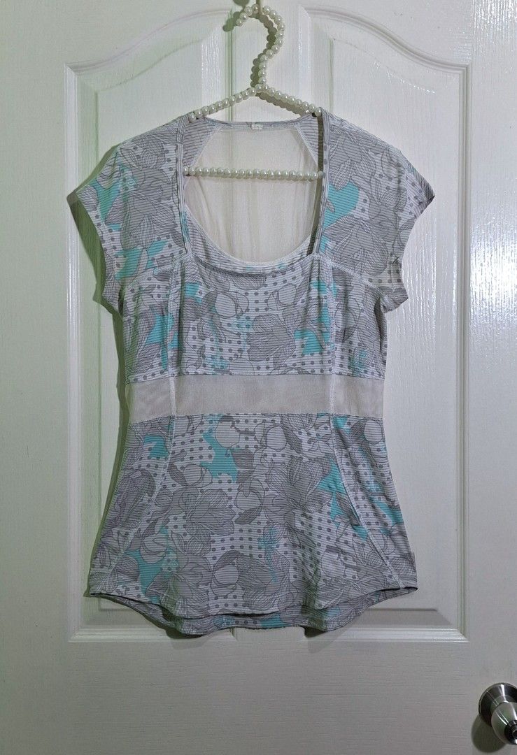 Lululemon tech run cap sleeve with mesh panel dot size 8 (Category: Activewear) located in San Pablo. Submitted by allyourbrandedneeds (Listing ID 1470139368, Image 2). Description: - Brand: Lululemon - Size: 8 - Color/Print: Grey, white, and teal with mixed floral and polka dot pattern - Design: Scoop neckline with a breathable mesh panel across the midsection - Fabric: Lightweight, airy, and sweat-friendly - Condition: Excellent.