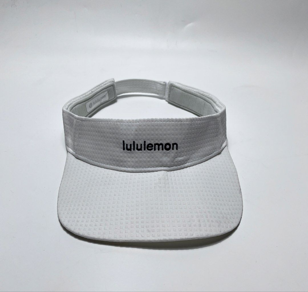 Lululemon White Athletic Visor (Category: Hats & Beanies) located in Iloilo. Submitted by fromthebins.ilo2 (Listing ID 1470106065, Image 1). Description: - Brand: Lululemon - Color: White with subtle textured pattern - Logo: Embroidered on the front panel and interior sweatband tag - Fit: Adjustable back strap with buckle and lululemon wordmark - Material: Lightweight and breathable athletic fabric - Ideal for: Running, tennis, golf, and outdoor 
