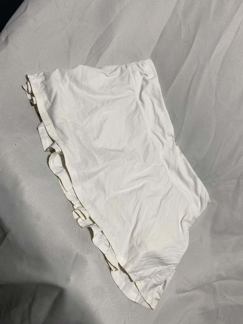 Lululemon White Ruffle Pleated Athletic Skort (Category: Skirts) located in Pasacao. Submitted by kishhuschka (Listing ID 1470079756, Image 2). Description: - Authentic white Lululemon athletic skirt - Built-in shorts for coverage and comfort - Trendy tiered ruffles on the front - Back zippered pocket and interior mesh pocket for essentials - Iconic Lululemon logo on the front and clear interior brand tag - Perfect for tennis, golf, or casual act