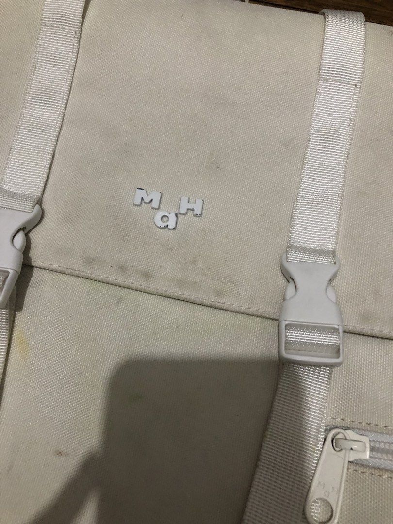 Mah White Canvas Backpack (Category: Backpacks) located in Caloocan City. Submitted by sopiya_pia (Listing ID 1470082482, Image 2). Description: White canvas backpack from Mah. Flap top with buckle closure and zipper pockets on the front. Mesh padded shoulder straps, adjustable webbed straps. Some minor yellow stains on the front canvas and light dirt marks near the top flap and logo. Lots of life left, great for school or daily commutes. Payment