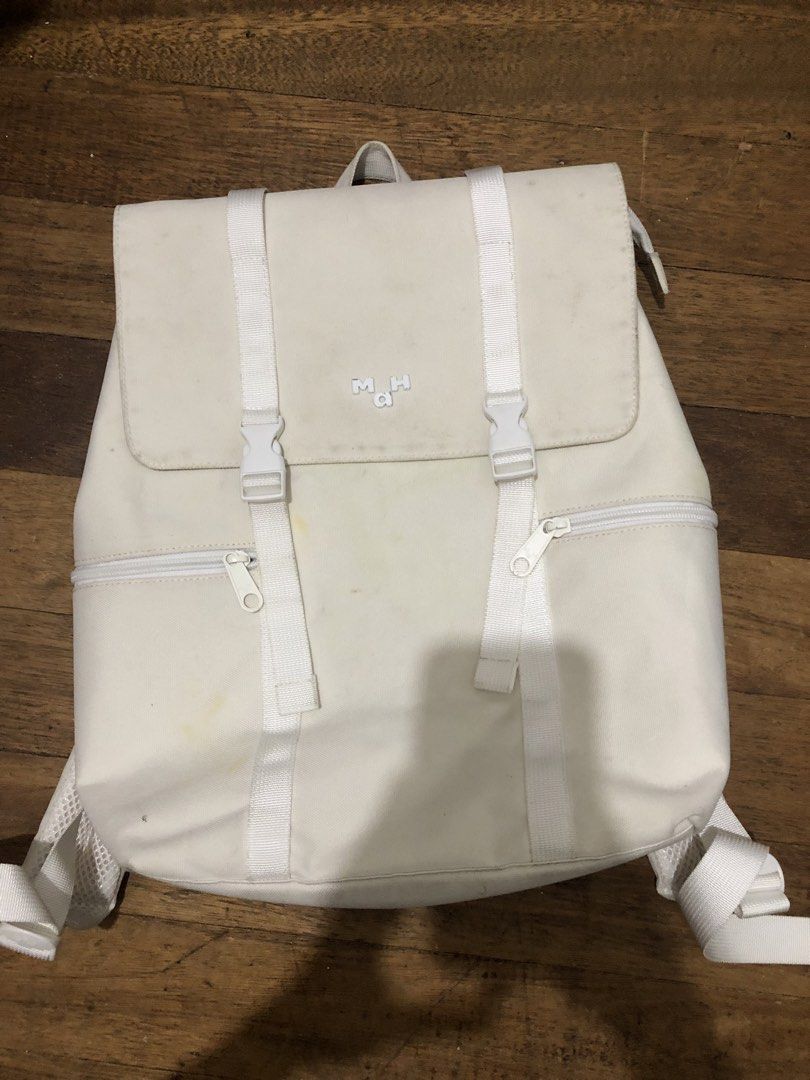Mah White Canvas Backpack (Category: Backpacks) located in Caloocan City. Submitted by sopiya_pia (Listing ID 1470082482, Image 1). Description: White canvas backpack from Mah. Flap top with buckle closure and zipper pockets on the front. Mesh padded shoulder straps, adjustable webbed straps. Some minor yellow stains on the front canvas and light dirt marks near the top flap and logo. Lots of life left, great for school or daily commutes. Payment