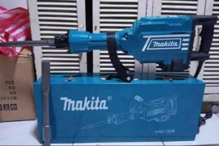 Makita HM1308 Demolition Hammer with Case and Bits (Category: Construction Tools & Equipment) located in Valenzuela. Submitted by mysticgem.f63ae6 (Listing ID 1469956073, Image 2). Description: - Brand/Model: Makita HM1308 Demolition Hammer - Condition: Clean, job-site ready - Build: Heavy-duty with iconic teal housing - Power: Corded for reliable, continuous heavy breaking work - Inclusions: Matching blue metal carrying case and two chisels.