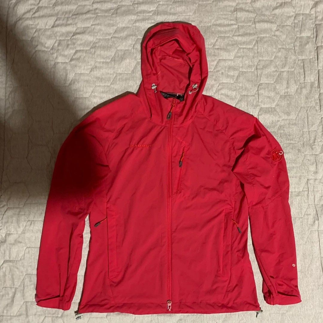 Mammut Red Hooded Outdoor Jacket (Category: Coats, Jackets and Outerwear) located in Dipolog. Submitted by en.en_mdkh (Listing ID 1470076252, Image 1). Description: - Brand: Mammut - Color: Bright red - Material: Lightweight shell, ideal for hiking or layering - Features: Attached hood, full zip front - Pockets: Secure zipped chest and side pockets - Fit: Adjustable drawcords at the hood and hem for a custom fit - Branding: Embroidered Mammut tex