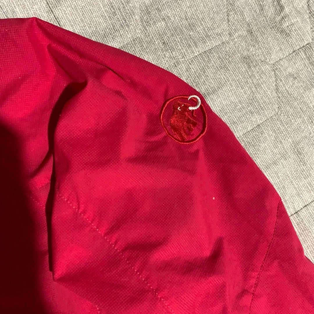 Mammut Red Hooded Outdoor Jacket (Category: Coats, Jackets and Outerwear) located in Dipolog. Submitted by en.en_mdkh (Listing ID 1470076252, Image 2). Description: - Brand: Mammut - Color: Bright red - Material: Lightweight shell, ideal for hiking or layering - Features: Attached hood, full zip front - Pockets: Secure zipped chest and side pockets - Fit: Adjustable drawcords at the hood and hem for a custom fit - Branding: Embroidered Mammut tex