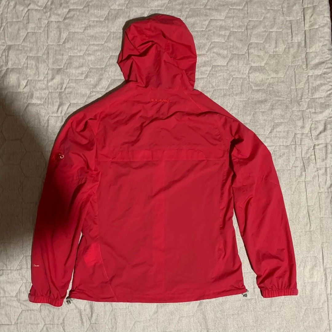 Mammut Red Hooded Outdoor Jacket (Category: Coats, Jackets and Outerwear) located in Dipolog. Submitted by en.en_mdkh (Listing ID 1470076252, Image 3). Description: - Brand: Mammut - Color: Bright red - Material: Lightweight shell, ideal for hiking or layering - Features: Attached hood, full zip front - Pockets: Secure zipped chest and side pockets - Fit: Adjustable drawcords at the hood and hem for a custom fit - Branding: Embroidered Mammut tex