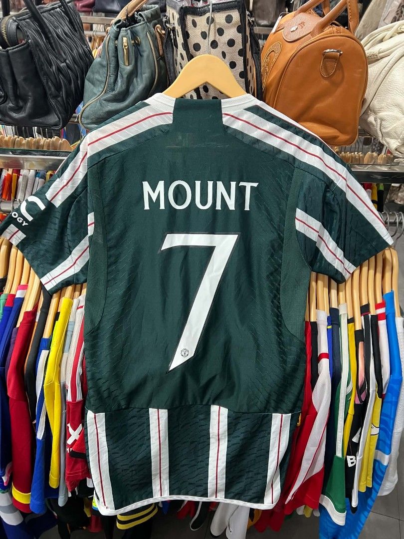 Manchester United Mount 7 Away Jersey (Category: Activewear) located in Urdaneta. Submitted by jayceegarage (Listing ID 1470095770, Image 2). Description: - Authentic Manchester United Away Jersey - Player: Mason Mount (#7) - Features TeamViewer sponsor, Adidas logo, and embroidered club crest - Includes official UEFA Foundation badge on the sleeve - Eye-catching green, white, and red striped pattern - Made in Vietnam with inner wash tag intact -