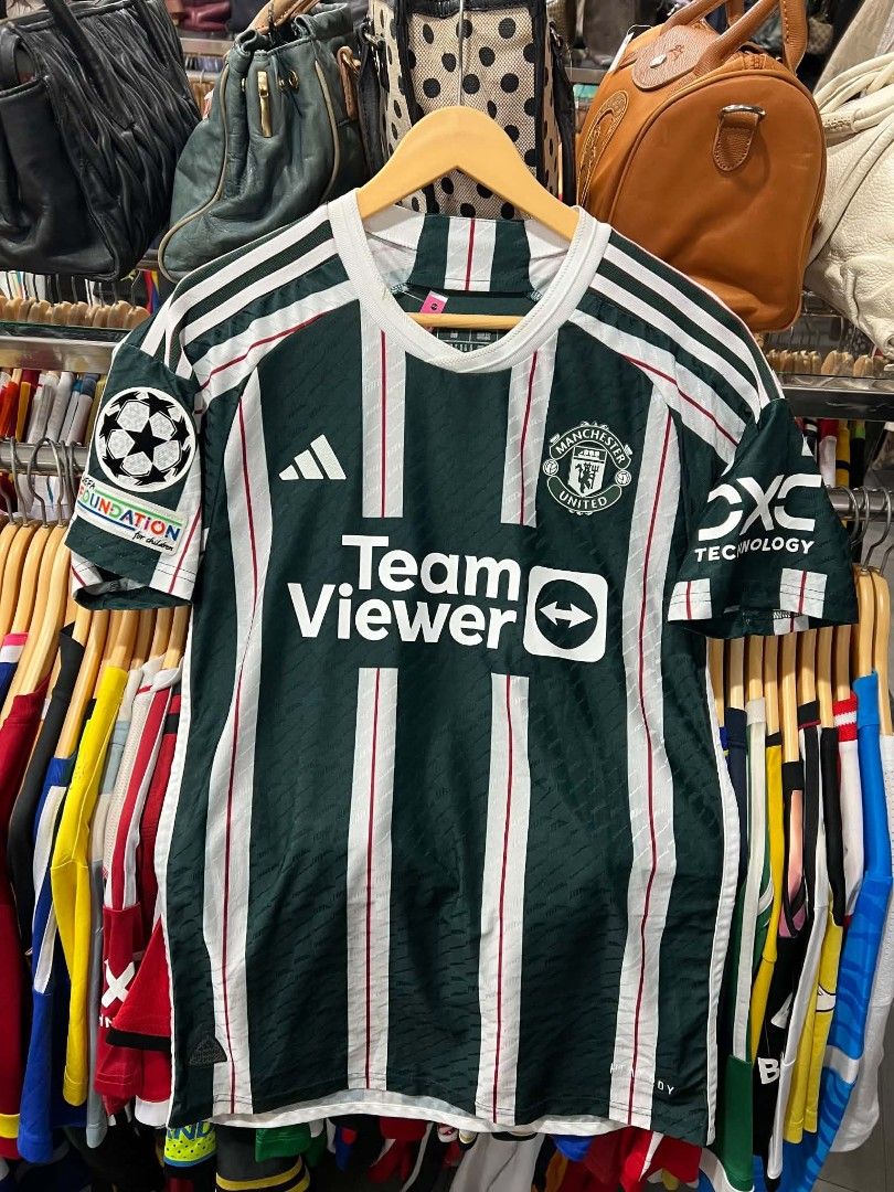 Manchester United Mount 7 Away Jersey (Category: Activewear) located in Urdaneta. Submitted by jayceegarage (Listing ID 1470095770, Image 1). Description: - Authentic Manchester United Away Jersey - Player: Mason Mount (#7) - Features TeamViewer sponsor, Adidas logo, and embroidered club crest - Includes official UEFA Foundation badge on the sleeve - Eye-catching green, white, and red striped pattern - Made in Vietnam with inner wash tag intact -