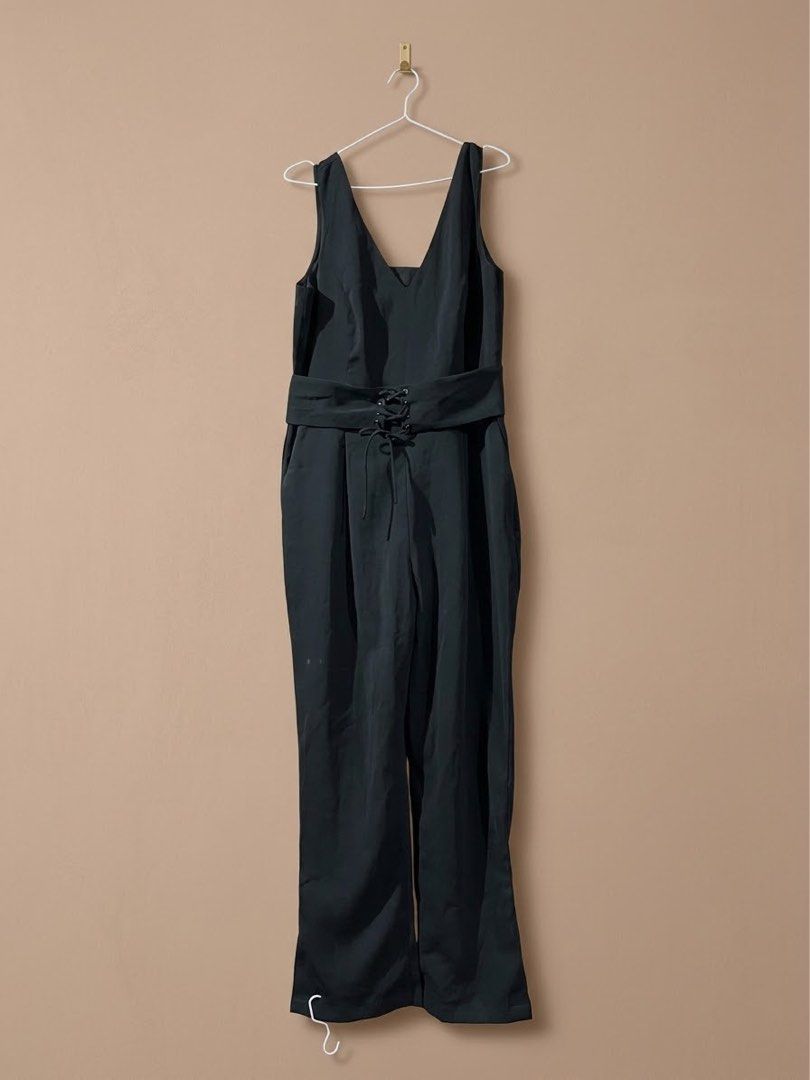 Mango Basics Black V-Neck Jumpsuit Size L (Category: Jumpsuits) located in Marikina City. Submitted by sakura_07 (Listing ID 1469954497, Image 1). Description: - Brand: Mango Basics - Color: Black - Size: L (EUR L / USA M) - Design: V-neckline with thick shoulder straps - Waist: Built-in belt with front lace-up corset detail - Cut: Long straight legs - Origin: Made in Vietnam.