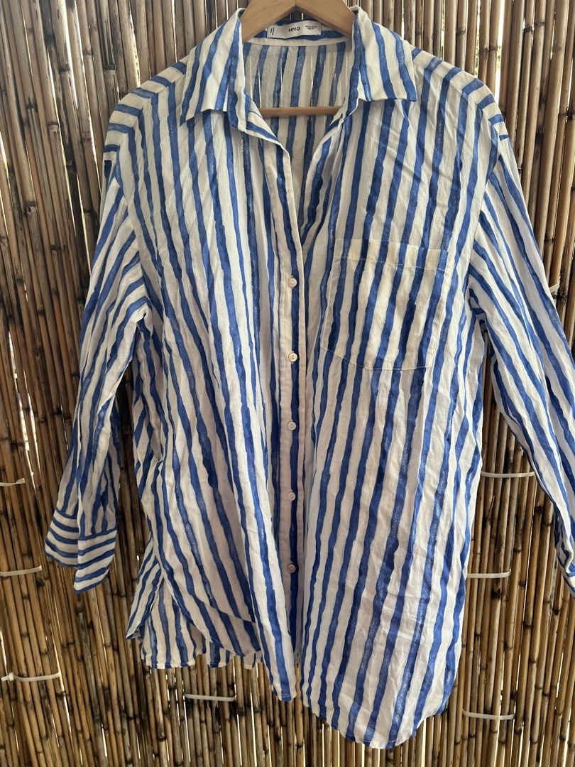 Mango Blue White Striped Button-Up Shirt Size M (Category: Blouses) located in Taguig. Submitted by bestthriftxx (Listing ID 1470012391, Image 2). Description: - Brand: Mango - Style: Blue and white striped button-up shirt - Size: EUR M / USA 6 / MEX M - Fit: Relaxed fit with long sleeves and button cuffs - Details: Classic collared neckline, front button closure, and one chest pocket - Material: Lightweight and comfortable for casual days or lay