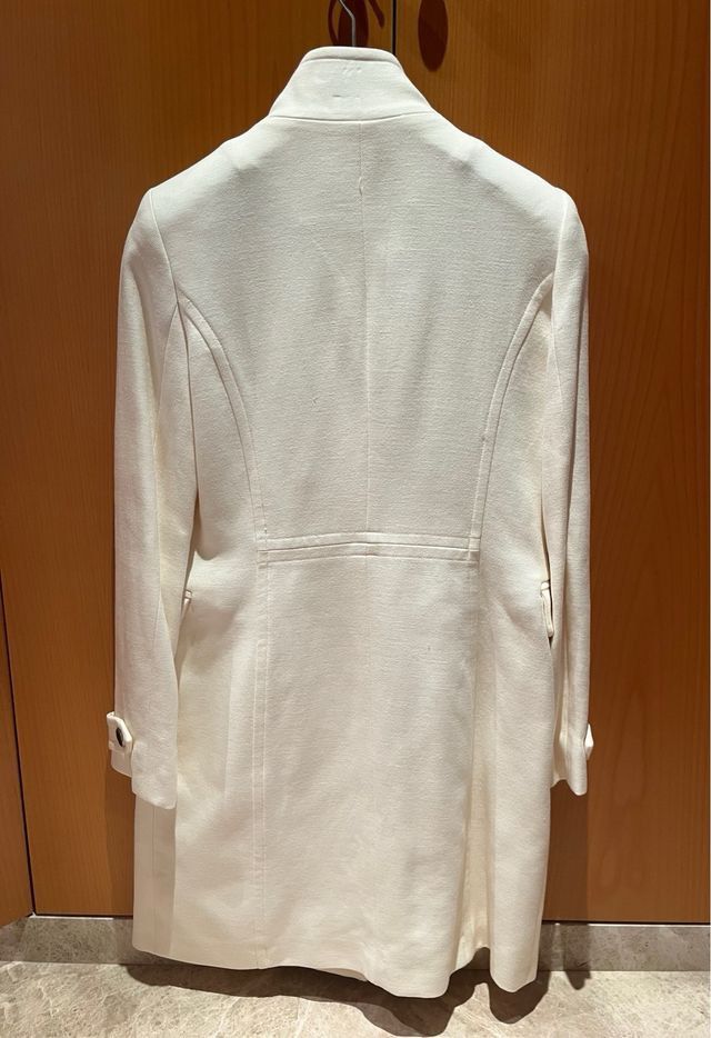Mango Cream Double Breasted Long Wool Coat (Category: Coats, Jackets and Outerwear) located in Pasig City. Submitted by helpmedispose (Listing ID 1469986033, Image 2). Description: - Color: Clean off-white / cream - Closure: Double-breasted button front - Material: Warm, cozy woolen fabric - Fit: Tailored back seams for a flattering, fitted silhouette - Details: Structured collar, front pocket flaps, and button cuffs - Length: Knee-length, perfec