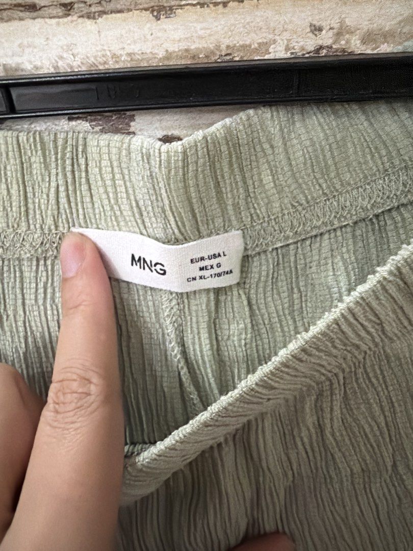 Mango Green Textured Wide Leg Pants Size L (Category: Jeans) located in Manila. Submitted by cb_____ (Listing ID 1469970351, Image 3). Description: - Brand: Mango - Color: Light green - Style: Relaxed, breezy wide leg pants - Material: Textured crinkle fabric - Waistband: Elastic for an easy and comfortable fit - Size: EUR-USA L, MEX G, CN XL-170/74A - Condition: Excellent, no flaws found.