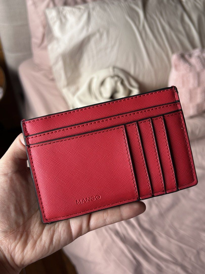 MANGO Red Saffiano Card Holder (Category: Wallets & Card holders) located in Cebu City. Submitted by shopmikascloset (Listing ID 1469955779, Image 1). Description: - Brand: MANGO - Material: Bright red Saffiano leather texture - Storage: Multiple card slots on front and back - Design: Compact size fits easily into pockets or small bags, featuring a crisp debossed logo - Condition: Great everyday accessory with minimal wear along the top edge near