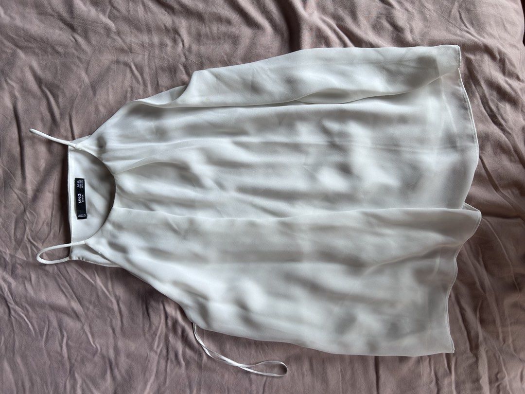 Mango White Halter Top (Category: Sleeveless) located in Cebu City. Submitted by shopmikascloset (Listing ID 1469956793, Image 2). Description: - Brand: Mango Basics - Color: White - Size: EUR XS / USA XXS - Material: Lightweight fabric with spaghetti straps - Details: Chic pleated neckline - Origin: Made in Indonesia.