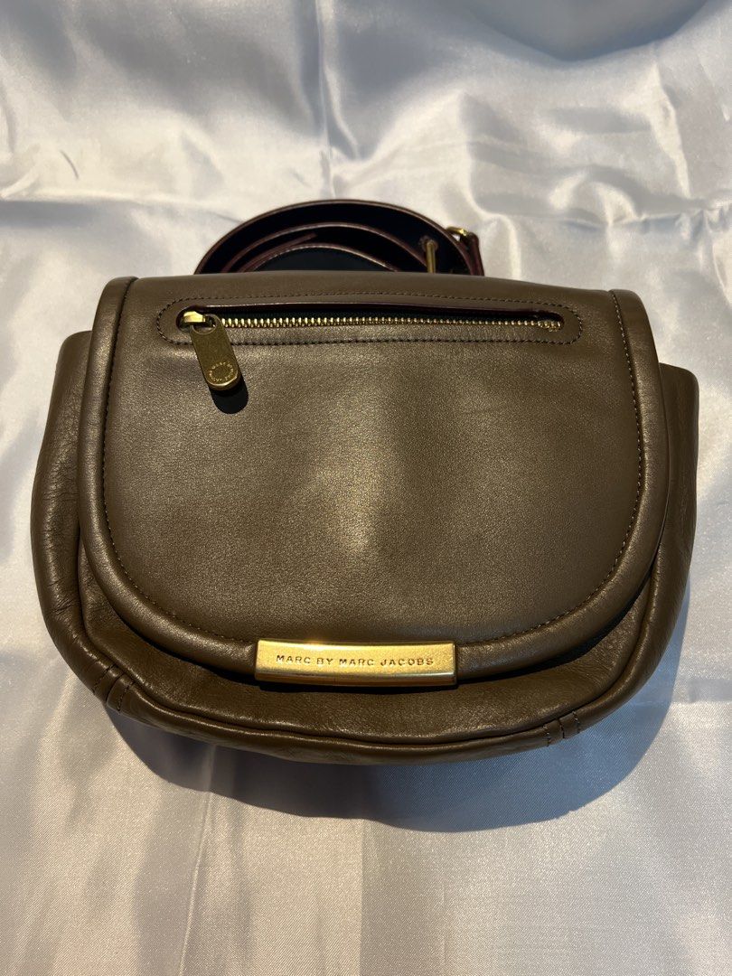 Marc by Marc Jacobs Leather Crossbody Bag Brown (Category: Cross-body Bags) located in Manila. Submitted by ghengdhoze (Listing ID 1470060561, Image 1). Description: - Brand: Marc by Marc Jacobs - Material: Genuine brown leather with burgundy fabric lining - Hardware: Gold-tone hardware with engraved front metal plate closure - Pockets: Exterior zip pocket on the flap and one interior zip pocket - Strap: Adjustable and detachable shoulder strap w