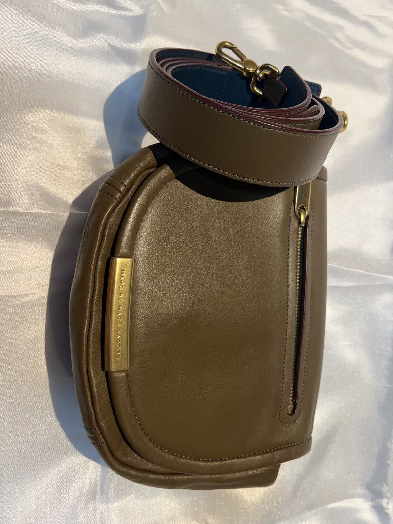 Marc by Marc Jacobs Leather Crossbody Bag Brown (Category: Cross-body Bags) located in Manila. Submitted by ghengdhoze (Listing ID 1470060561, Image 2). Description: - Brand: Marc by Marc Jacobs - Material: Genuine brown leather with burgundy fabric lining - Hardware: Gold-tone hardware with engraved front metal plate closure - Pockets: Exterior zip pocket on the flap and one interior zip pocket - Strap: Adjustable and detachable shoulder strap w