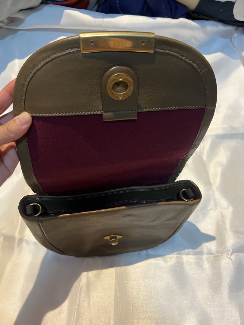 Marc by Marc Jacobs Leather Crossbody Bag Brown (Category: Cross-body Bags) located in Manila. Submitted by ghengdhoze (Listing ID 1470060561, Image 3). Description: - Brand: Marc by Marc Jacobs - Material: Genuine brown leather with burgundy fabric lining - Hardware: Gold-tone hardware with engraved front metal plate closure - Pockets: Exterior zip pocket on the flap and one interior zip pocket - Strap: Adjustable and detachable shoulder strap w