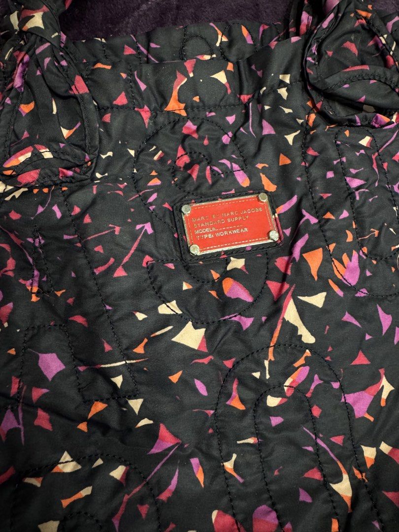 Marc by Marc Jacobs Workwear Quilted Tote Bag (Category: Tote Bags) located in Valenzuela. Submitted by sofiasticated.decluttering (Listing ID 1470085321, Image 2). Description: - Authentic Marc by Marc Jacobs quilted tote bag - Eye-catching black multi-colored geometric/abstract print - Signature red brand plaque on the front - Secure top zip closure with double handles - Spacious interior lined in black and white monogram fabric with a convenie