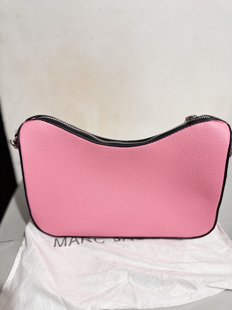 Marc Jacobs Pink Shoulder Bag with Strap (Category: Luxury Bags & Wallets) located in Mabalacat. Submitted by kay_miscak (Listing ID 1470093689, Image 3). Description: -Marc Jacobs shoulder bag in bright pink pebbled leather - Chic black trim along the zipper and edges with sleek silver hardware - Features a stylish side padlock detail and a structured base to keep its clean shape - Comes with an extra interchangeable pink fabric logo strap - Inc