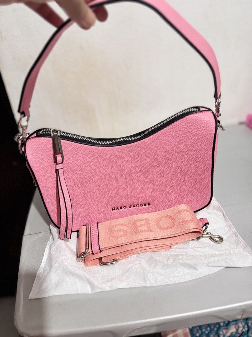 Marc Jacobs Pink Shoulder Bag with Strap (Category: Luxury Bags & Wallets) located in Mabalacat. Submitted by kay_miscak (Listing ID 1470093689, Image 1). Description: -Marc Jacobs shoulder bag in bright pink pebbled leather - Chic black trim along the zipper and edges with sleek silver hardware - Features a stylish side padlock detail and a structured base to keep its clean shape - Comes with an extra interchangeable pink fabric logo strap - Inc
