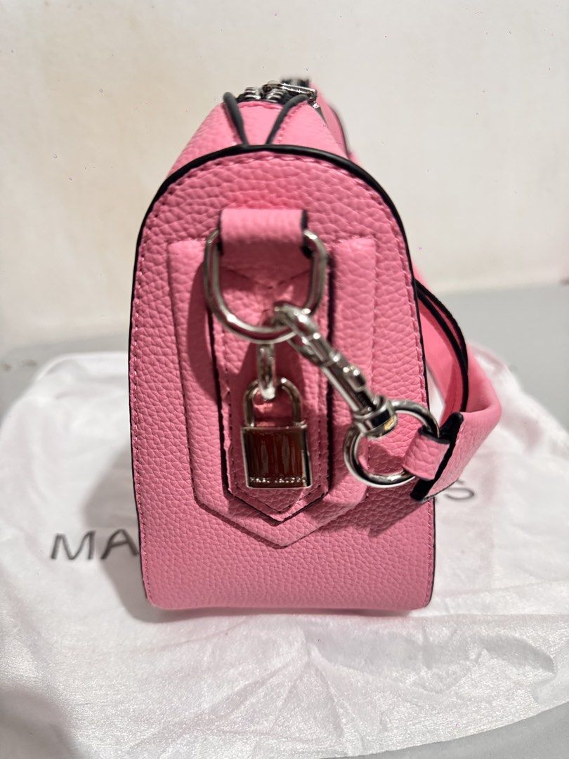 Marc Jacobs Pink Shoulder Bag with Strap (Category: Luxury Bags & Wallets) located in Mabalacat. Submitted by kay_miscak (Listing ID 1470093689, Image 2). Description: -Marc Jacobs shoulder bag in bright pink pebbled leather - Chic black trim along the zipper and edges with sleek silver hardware - Features a stylish side padlock detail and a structured base to keep its clean shape - Comes with an extra interchangeable pink fabric logo strap - Inc