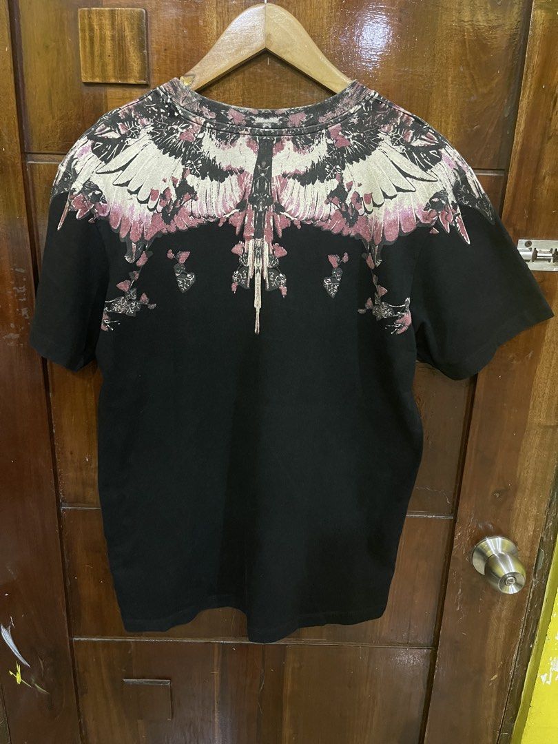 Marcelo Burlon Shirt (Category: Luxury Apparel) located in Marikina City. Submitted by greatfindsmnlph (Listing ID 1470135348, Image 3). Description: Mar celo Bur lon Shirt Price: 250 Size: Medium Width: 21 Length: 28 Color: Black Color Rate: 10/10 Condition: 9.9/10 may pinhole Very nice in actual.